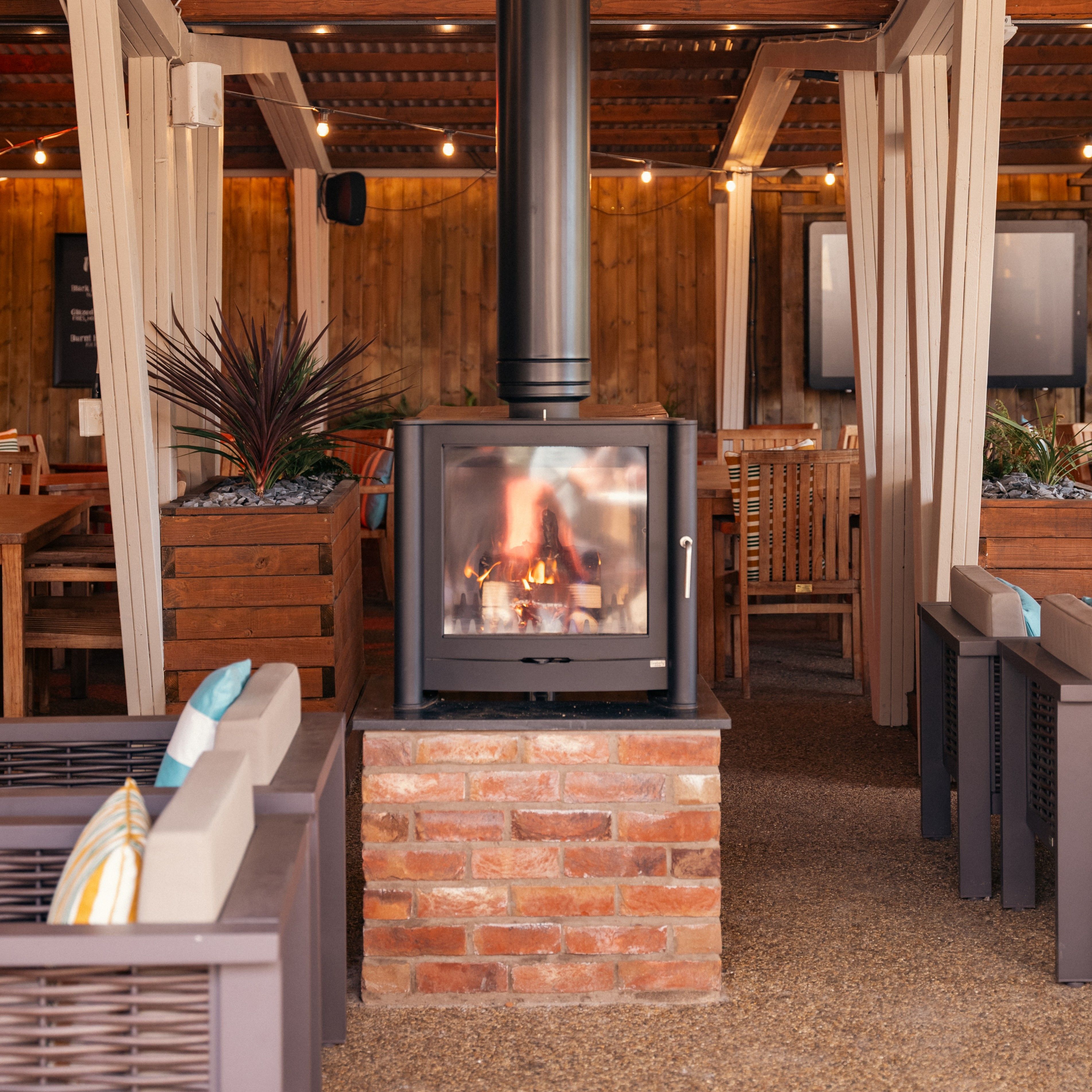 a cosy fire in the outdoor barn area
